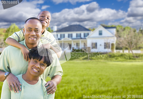 Image of African American Family In Front of Beautiful House