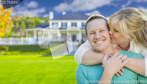 Image of Happy Couple Hugging In Front of House