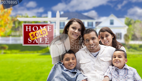 Image of Hispanic Family in Front of Sold Real Estate Sign, House