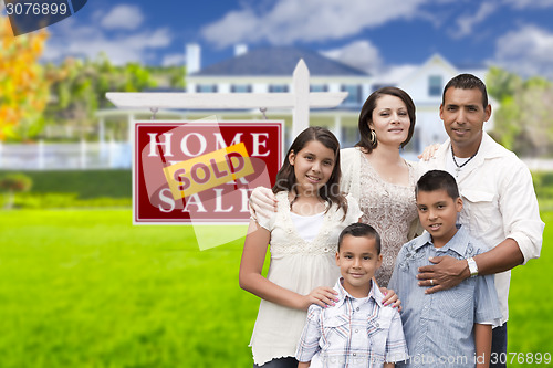 Image of Hispanic Family in Front of Sold Real Estate Sign, House