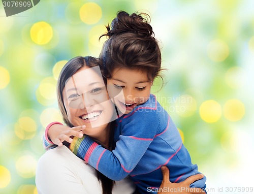 Image of happy mother and daughter hugging