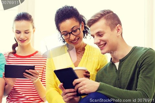 Image of smiling students with tablet pc at school