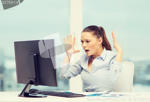 Image of stressed woman with computer