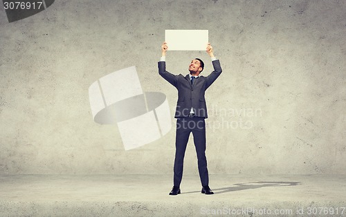 Image of smiling businessman with white blank board