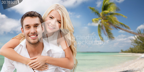 Image of happy couple having fun over beach background