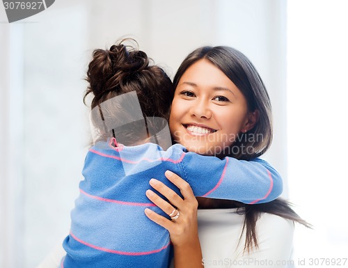 Image of hugging mother and daughter