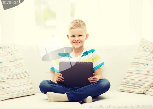 Image of smiling boy with tablet computer at home