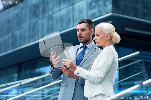 Image of businesspeople with tablet pc outdoors