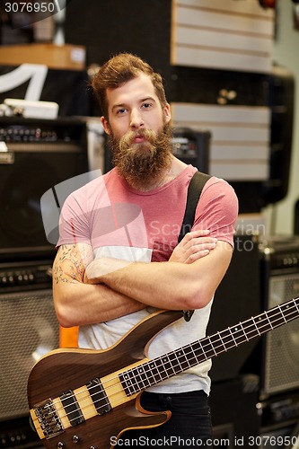 Image of musician or customer with guitar at music store