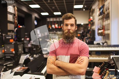 Image of assistant or customer with beard at music store