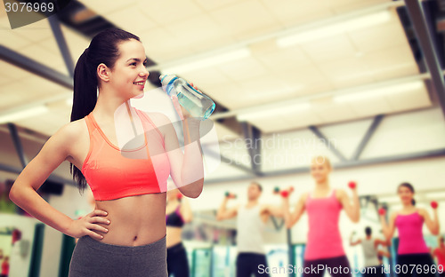 Image of sporty woman with water bottle