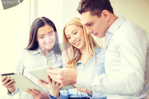 Image of business team working with tablet pcs in office