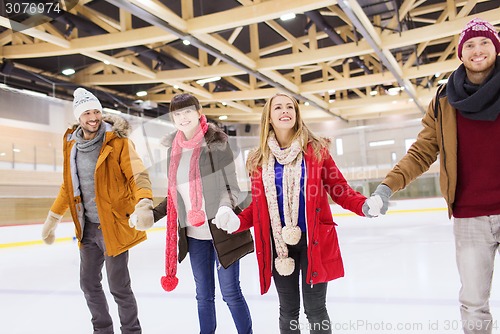 Image of happy friends on skating rink