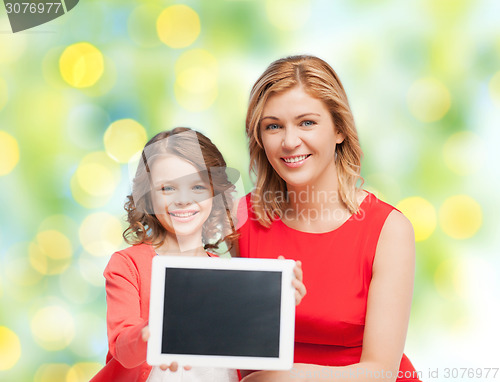 Image of mother and daughter with tablet pc over green