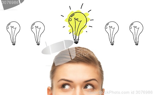 Image of close up of woman looking to lighting bulbs