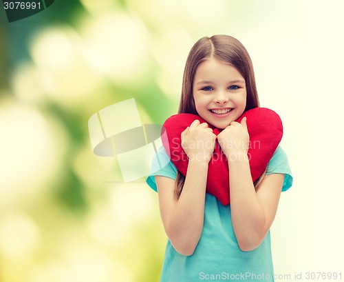 Image of smiling little girl with red heart