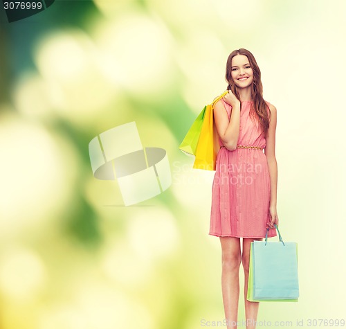 Image of smiling woman in dress with many shopping bags