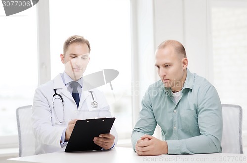 Image of doctor with clipboard and patient in hospital