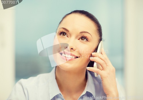 Image of african businesswoman with smartphone in office