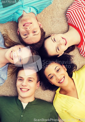 Image of group of smiling people lying down on floor