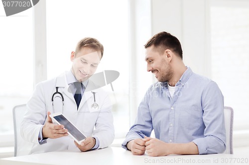 Image of doctor with tablet pc and patient in hospital