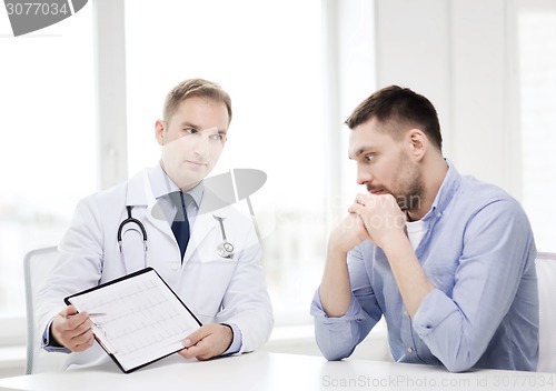 Image of doctor with clipboard and patient in hospital