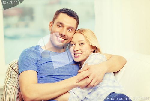 Image of smiling happy couple at home