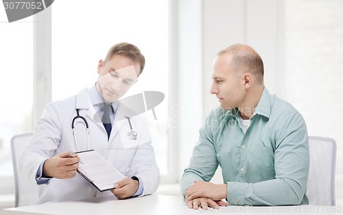 Image of doctor with clipboard and patient in hospital