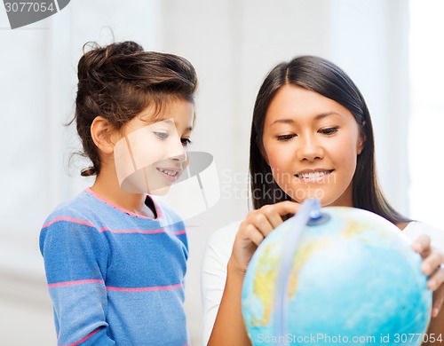 Image of mother and daughter with globe