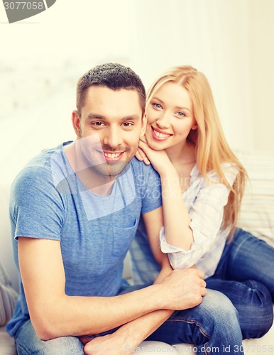 Image of smiling happy couple at home