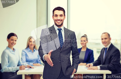 Image of businessman with open hand ready for handshake
