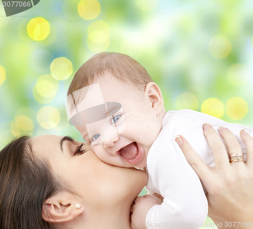 Image of happy mother with baby over green background