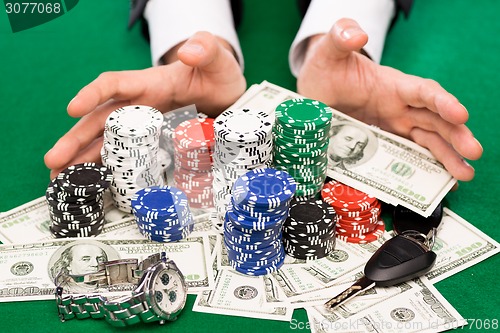 Image of poker player with chips and money at casino table