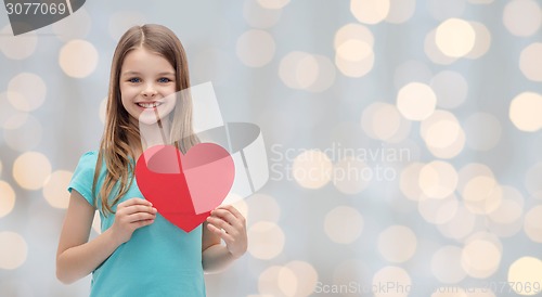 Image of smiling little girl with red heart