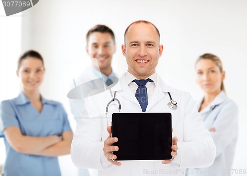 Image of smiling male doctor with stethoscope and tablet pc