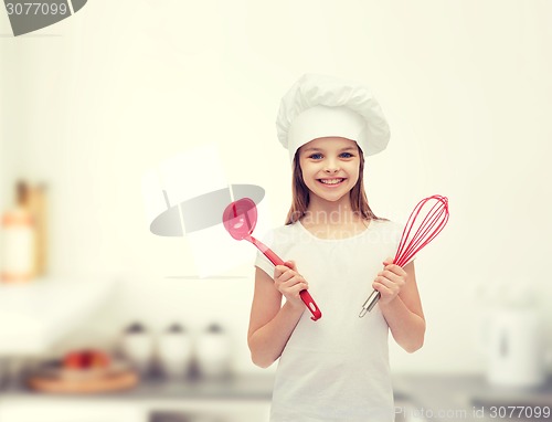 Image of smiling girl in cook hat with ladle and whisk