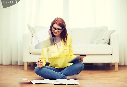 Image of student with tablet pc computer and notebooks