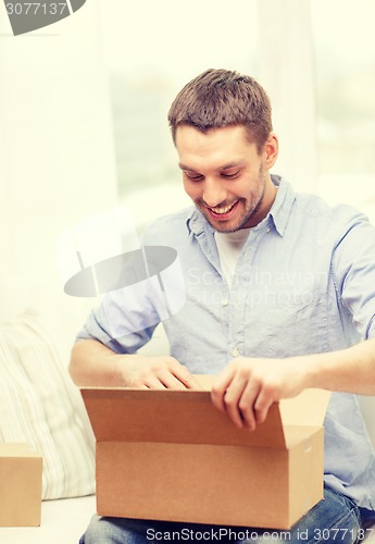 Image of man with cardboard boxes at home