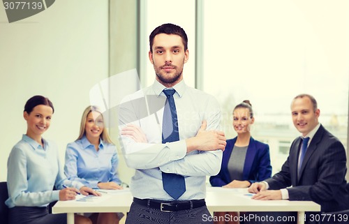 Image of handsome businessman with crossed arms