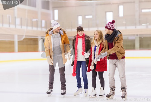 Image of happy friends on skating rink