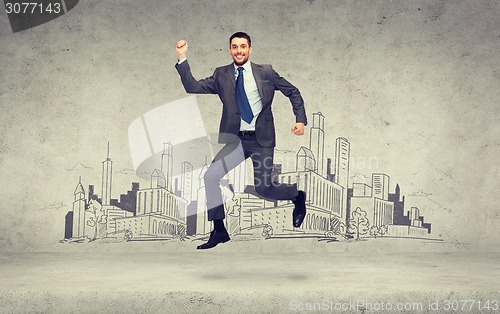 Image of smiling businessman jumping