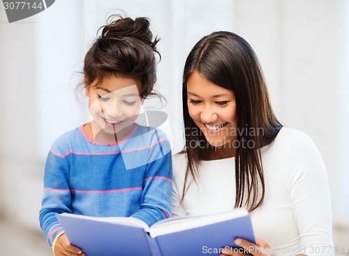 Image of mother and daughter with book