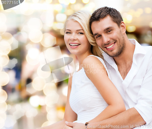 Image of happy couple having fun over lights background