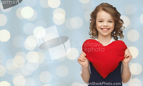 Image of smiling little girl with red heart