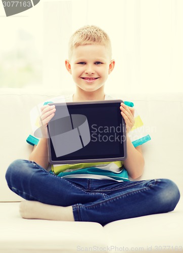 Image of smiling boy with tablet pc computer at home