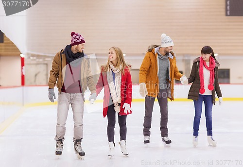 Image of happy friends on skating rink