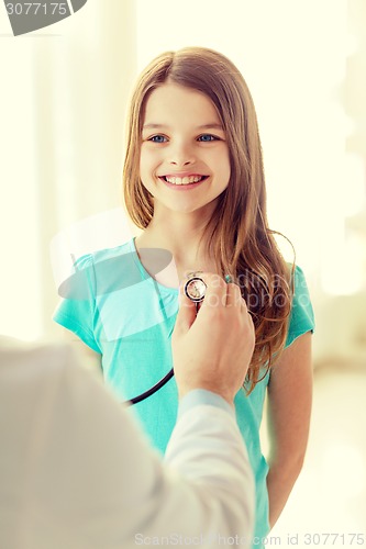 Image of male doctor with stethoscope listening to child