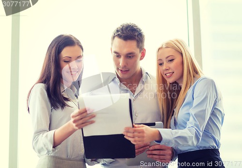 Image of business team looking at clipboard