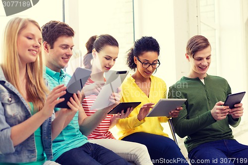 Image of smiling students with tablet pc at school