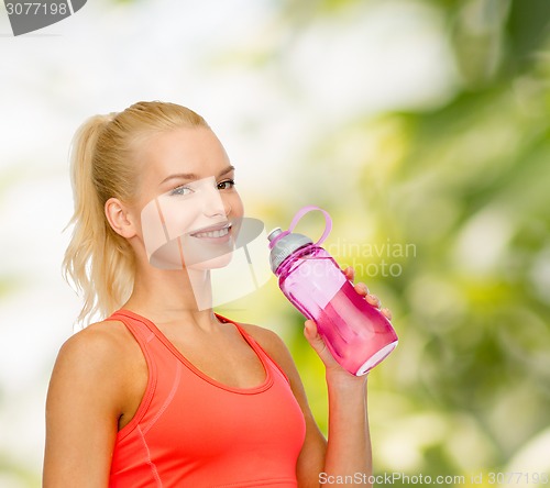 Image of smiling sporty woman with water bottle